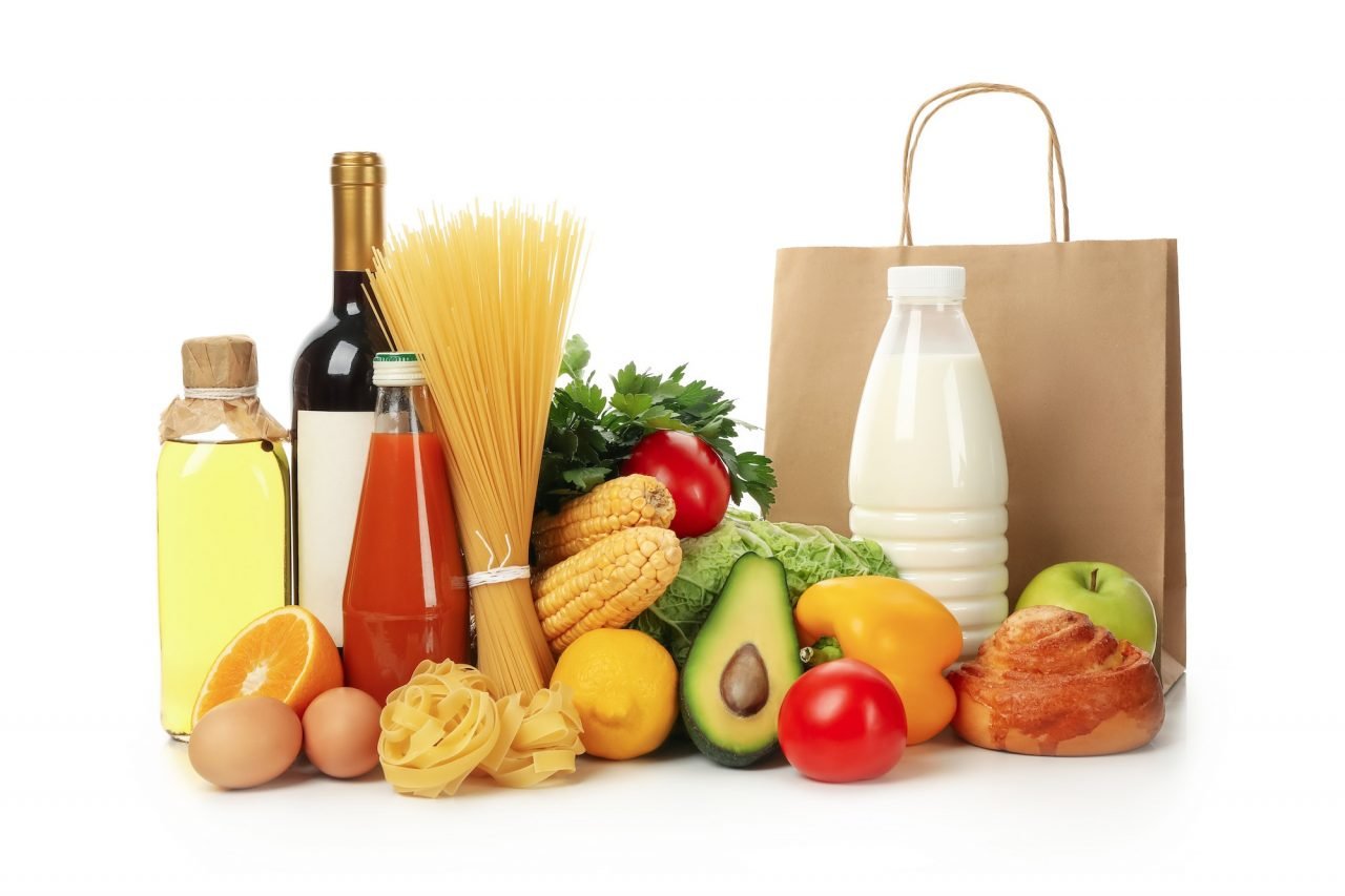 Paper bag and different food isolated on white background